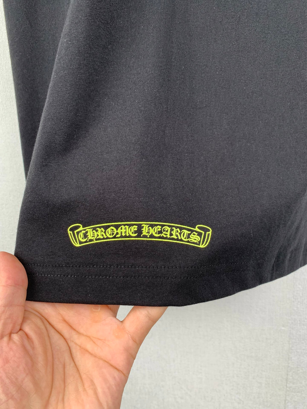 Chrome shorts with yellow logo patch at hem