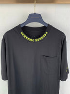 Black crew-neck T-shirt with neon green script logo across the collar and front pocket