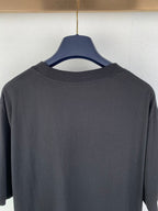 Black crew-neck T-shirt back close-up of collar and upper yoke