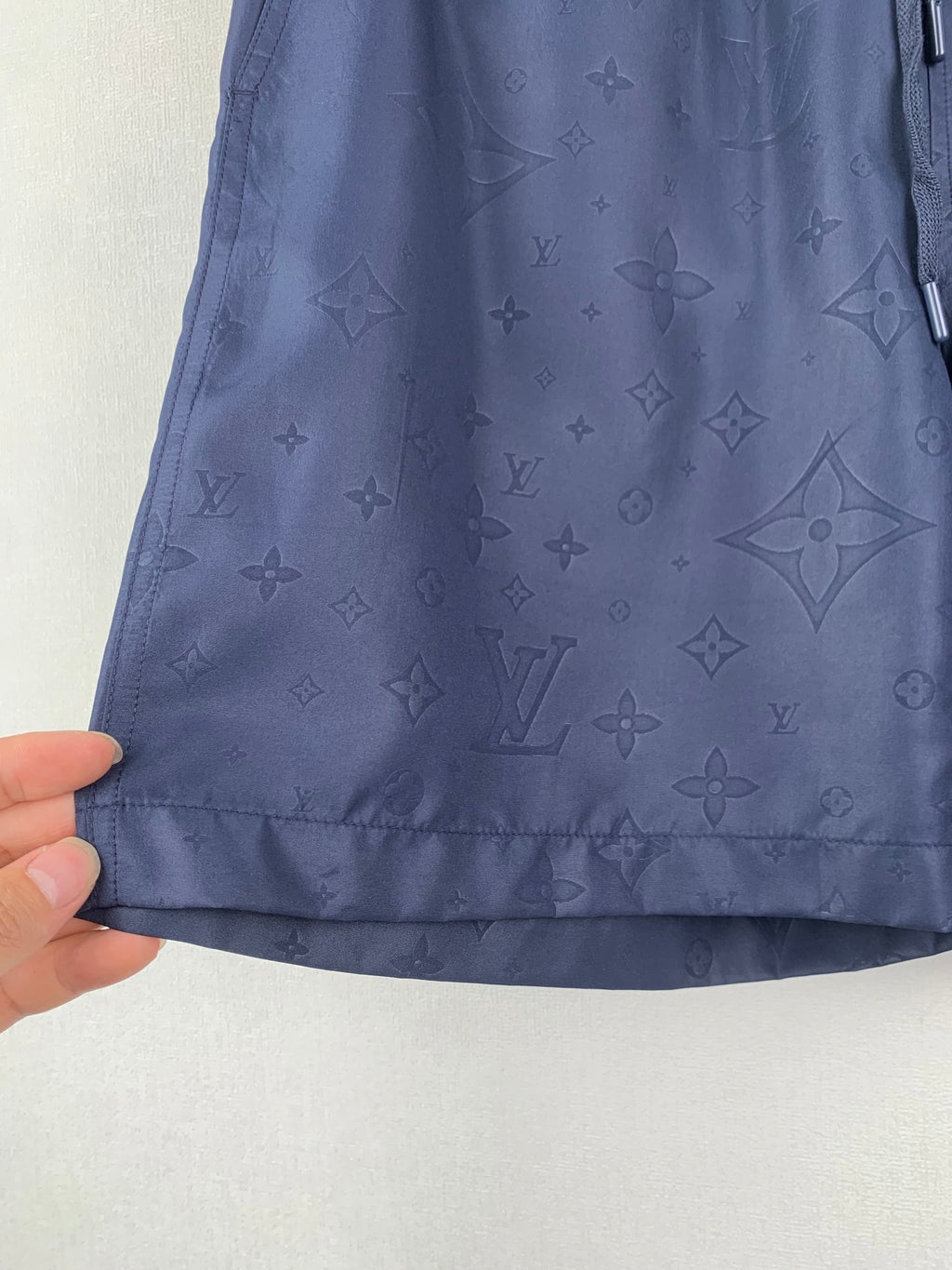 Louis Vuitton monogram shorts lower hem and fabric texture, dark navy