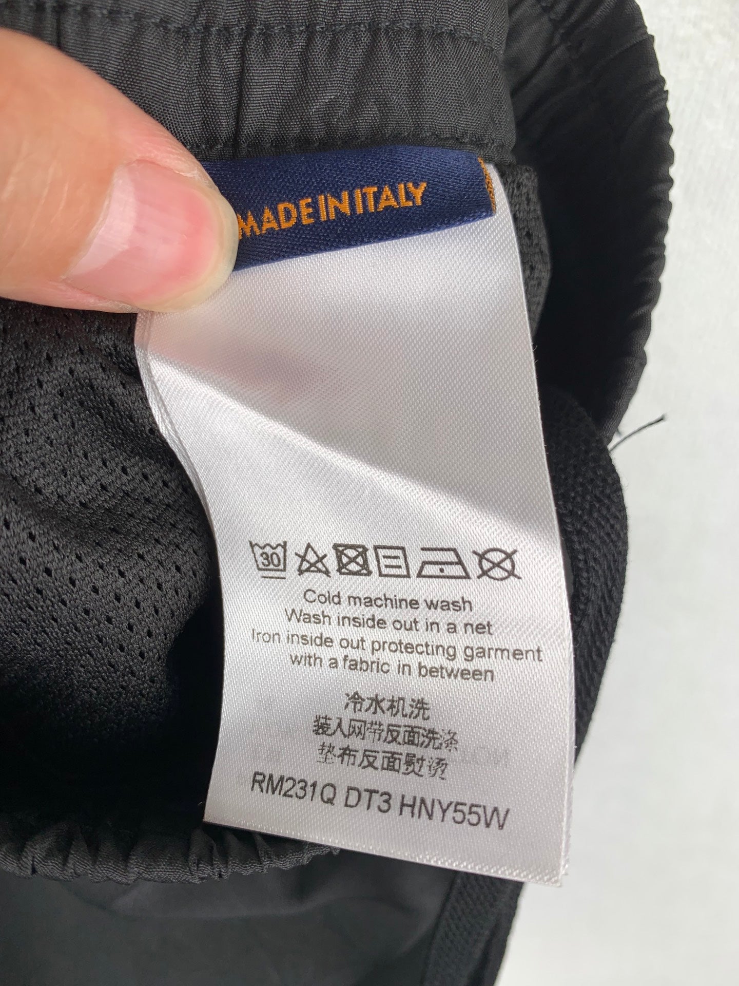 Louis Vuitton pants care label with MADE IN ITALY text and washing instructions