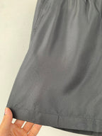 Louis Vuitton black shorts fabric close-up with subtle embossed pattern