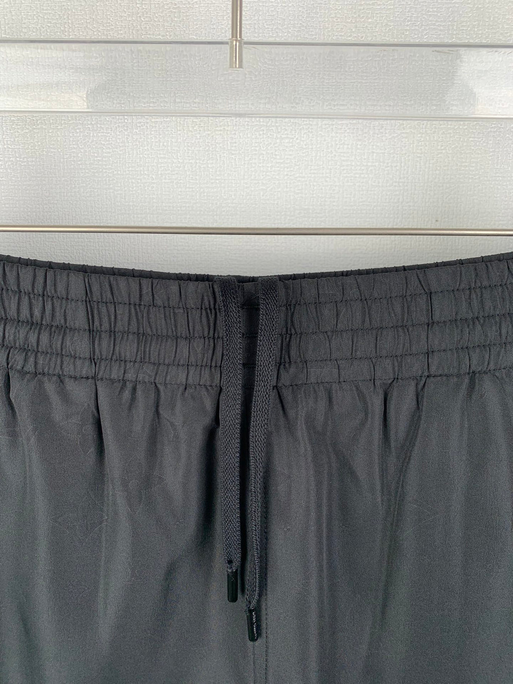 Louis Vuitton black drawstring waistband close-up with stitched elastic texture