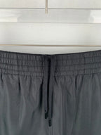 Louis Vuitton black drawstring waistband close-up with stitched elastic texture