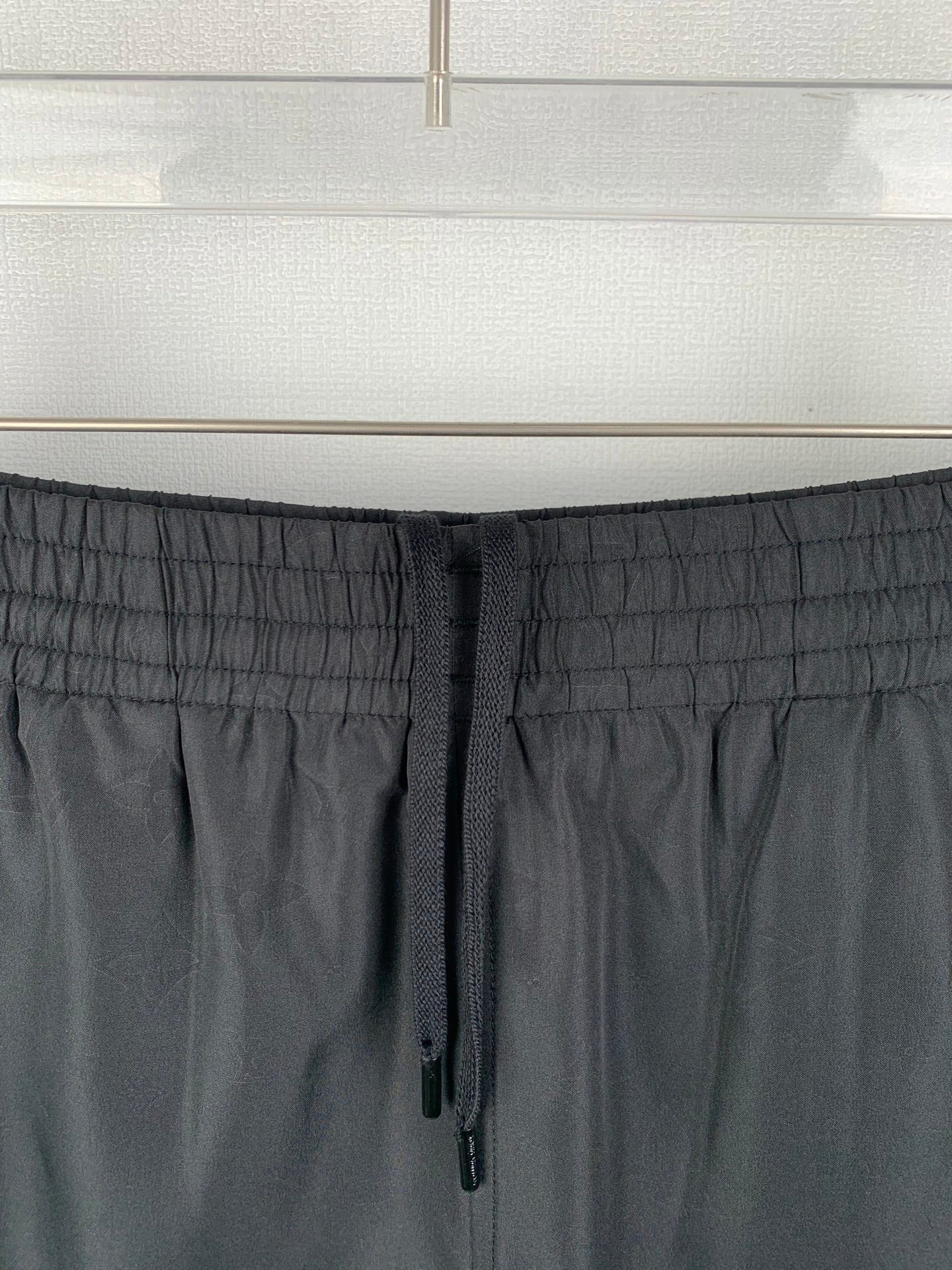 Louis Vuitton black drawstring waistband close-up with stitched elastic texture