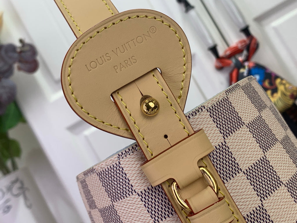 Louis Vuitton logo leather tab with gold hardware on tan-trim checkered bag