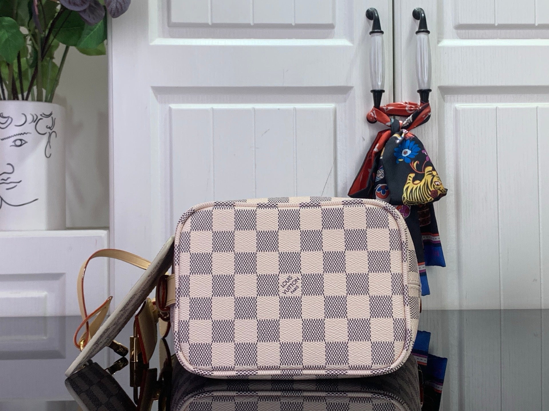 Louis Vuitton checkered mini bag with zipper top and leather wrist strap