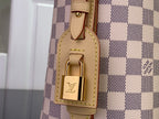 Louis Vuitton lock detail on tan leather strap attached to checkered bag panel