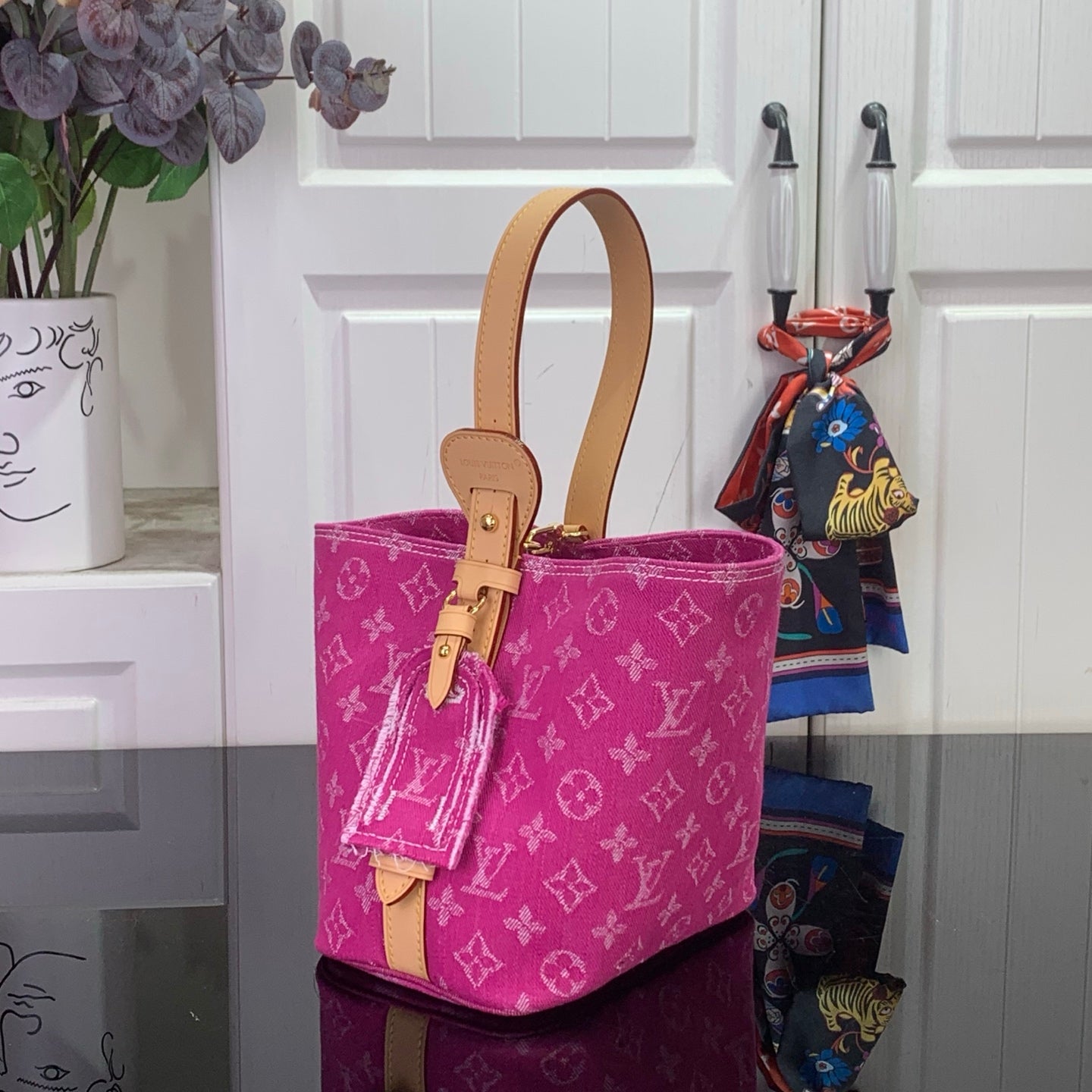 Purple monogram shopping bag with tan handles and hanging charm