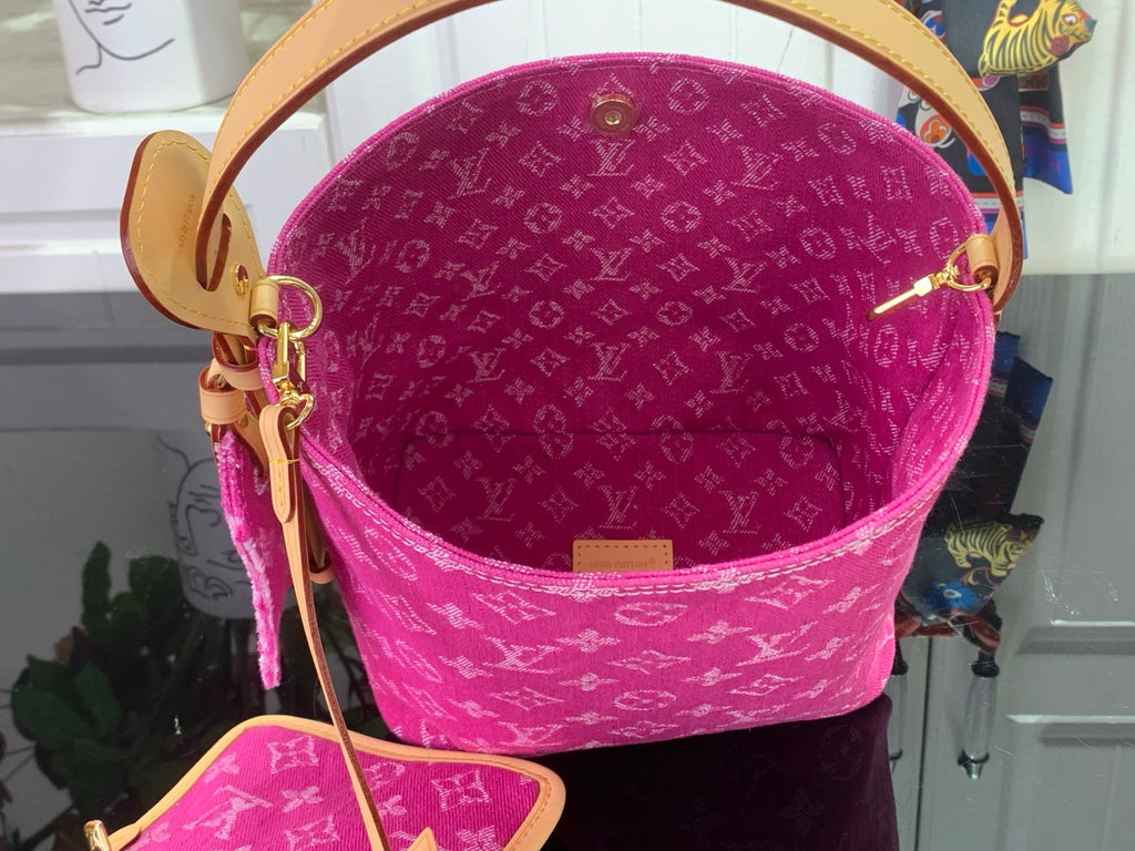 Louis Vuitton bucket bag in magenta with monogram pattern, top handle and strap