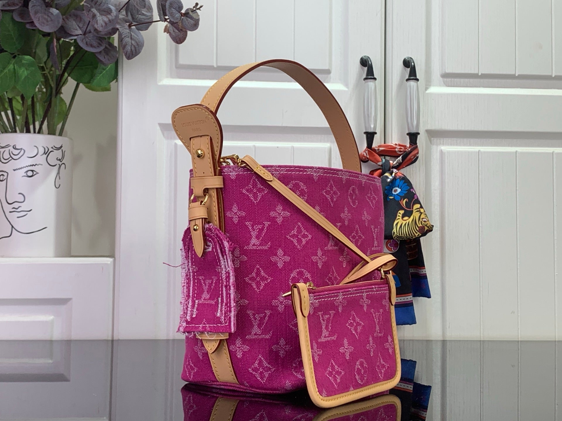 Purple monogram shoulder bag with tan handles and crossbody strap