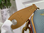 Louis Vuitton monogram bag strap close-up on tan leather with blue body
