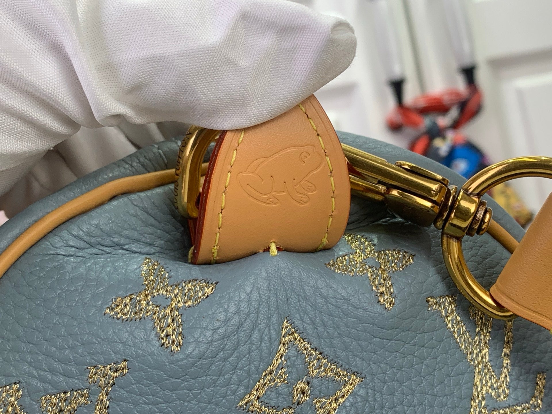 Louis Vuitton monogram bag corner with tan charm and gold star pattern