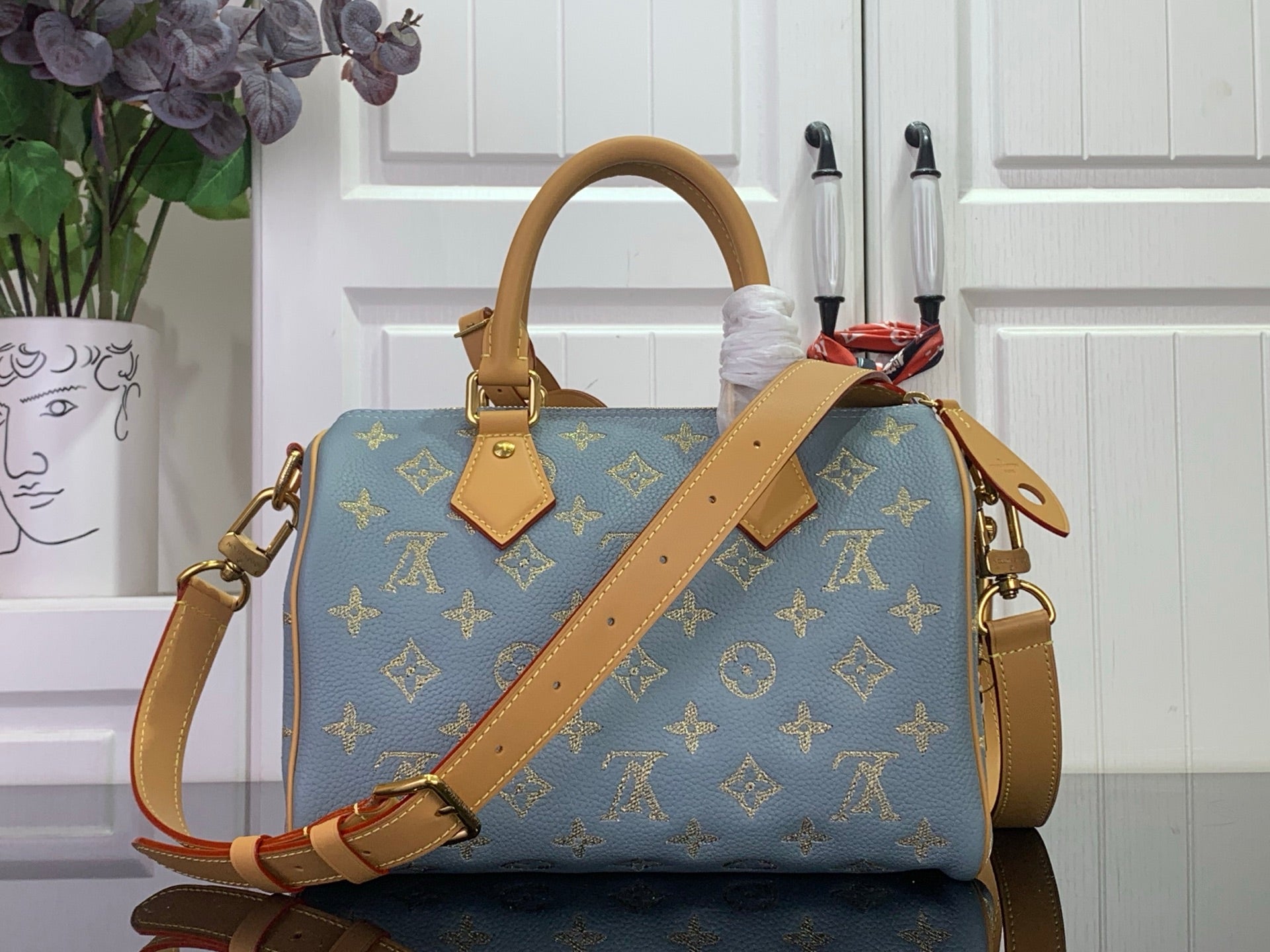 Louis Vuitton monogram bag, blue with tan leather crossbody strap and top handle