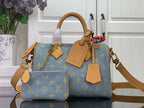 Louis Vuitton monogram bag in blue with tan leather handles and shoulder strap