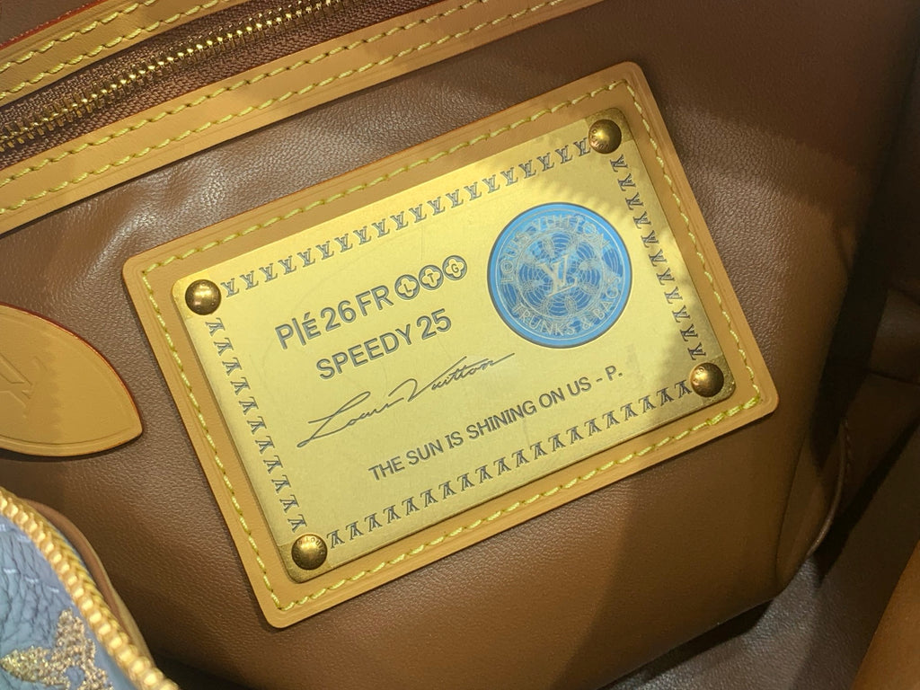 Louis Vuitton interior label patch in gold frame with logo and serial text
