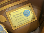 Louis Vuitton interior label patch in gold frame with logo and serial text