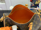 Louis Vuitton monogram bag open top showing orange interior lining and zipper
