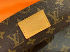 Louis Vuitton monogram bag close-up of tan logo patch on patterned strap