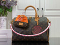 Louis Vuitton monogram handbag with tan leather handles and orange accessory pouch
