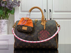 Louis Vuitton monogram handbag with tan leather handles and orange accessory pouch