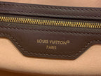 Louis Vuitton bag logo on brown leather panel with gold zipper trim