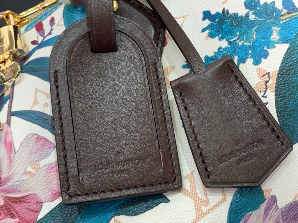 Brown leather handbag accessories with stitched edges and embossed lettering