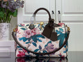 Louis Vuitton handbag with floral print, white base, teal and pink flowers, brown handles