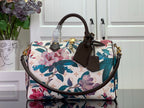 Louis Vuitton handbag with floral print, white base, teal and pink flowers, brown handles