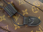 Louis Vuitton monogram bag strap loop with black leather tab and stitching
