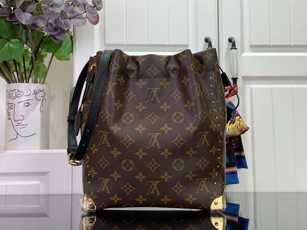 Louis Vuitton monogram bag with black crossbody strap, dark brown back view