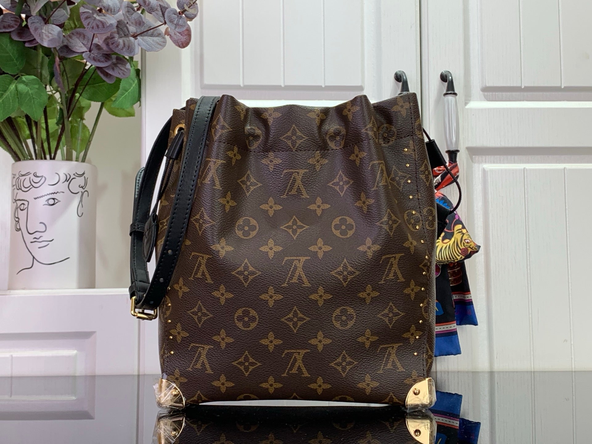 Louis Vuitton monogram bag with black crossbody strap, dark brown back view