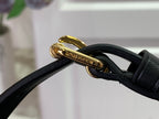 Louis Vuitton bag clasp with black leather strap and gold hardware