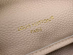 Light beige textured leather Louis Vuitton Paris logo with gold embossed letters