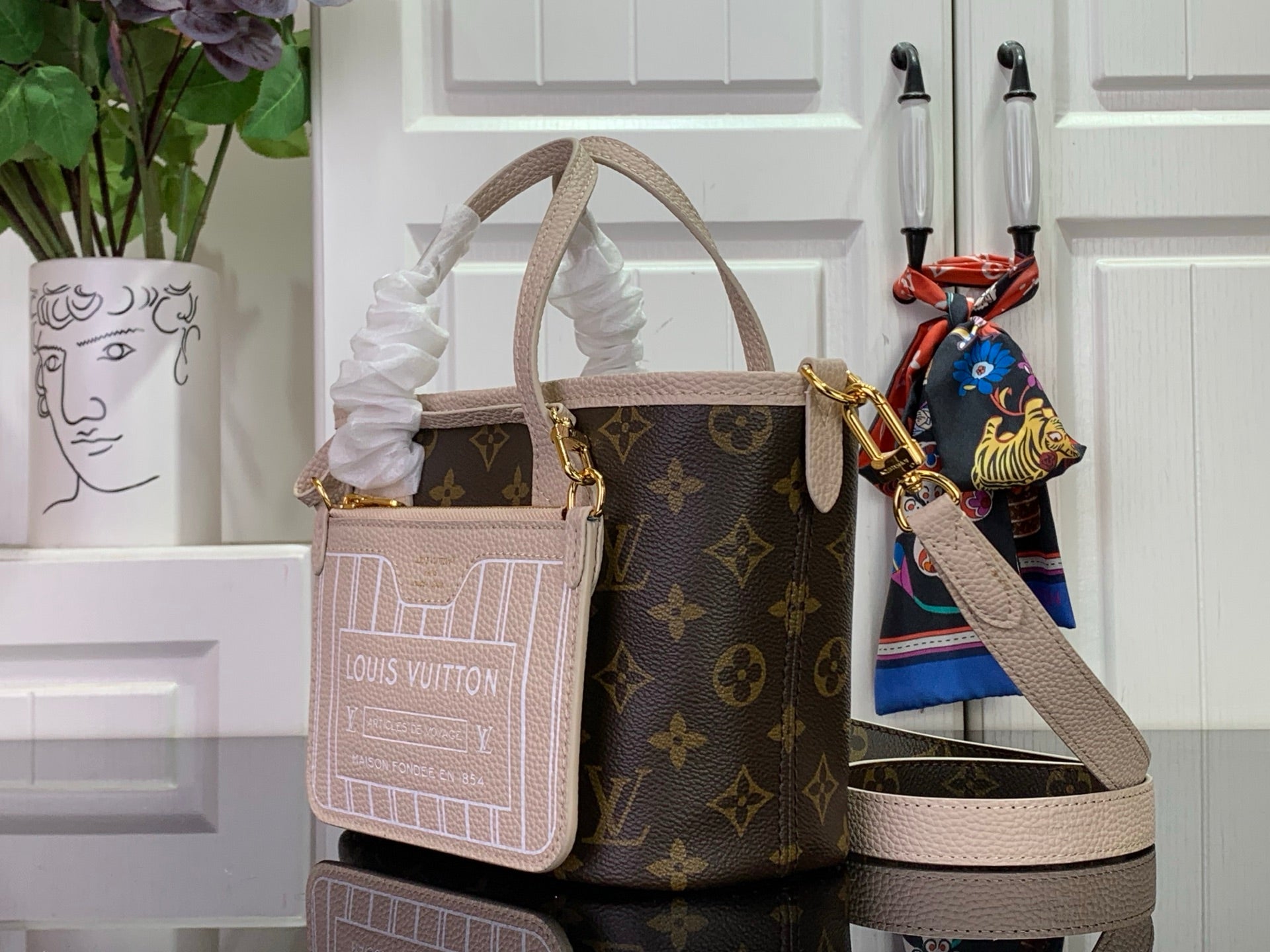 Louis Vuitton monogram tote bag and small crossbody pouch with pale strap and gold hardware