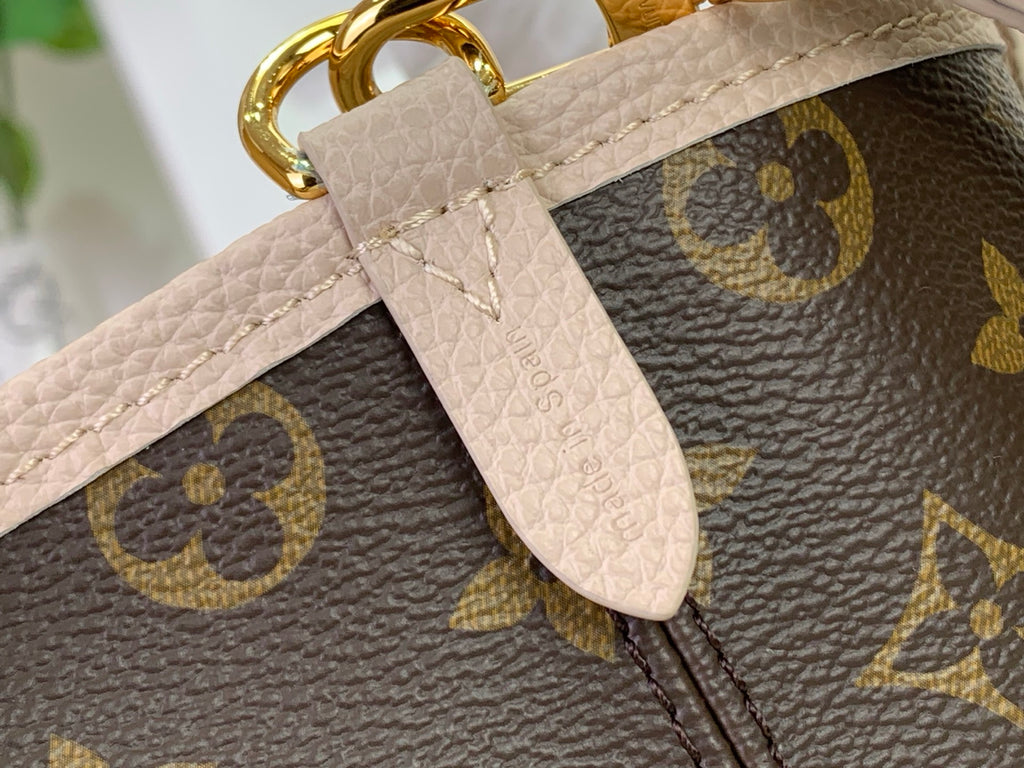 Louis Vuitton monogram tote bag strap close-up with pale leather and gold ring hardware