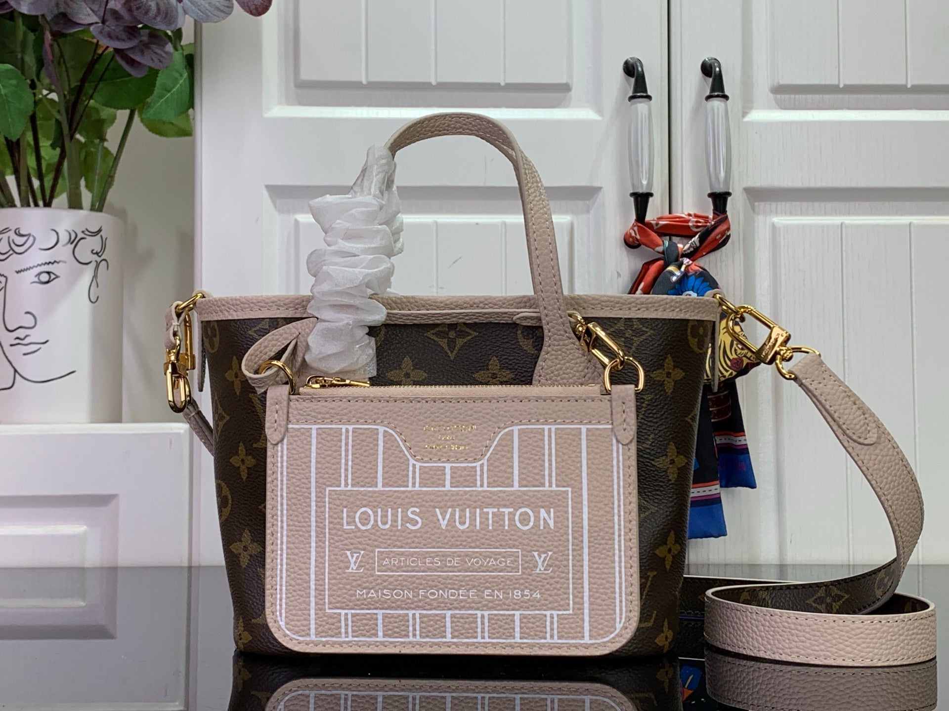 Louis Vuitton monogram tote bag with pale leather handles and matching small pouch