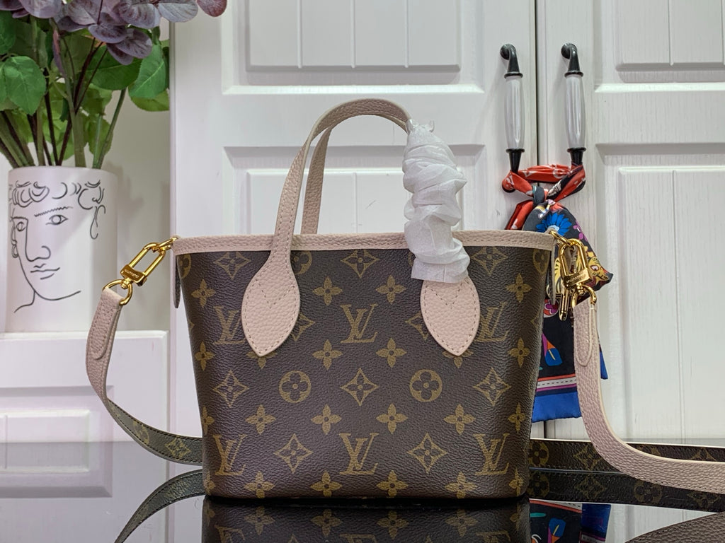 Louis Vuitton monogram tote bag with pale leather handles and side strap