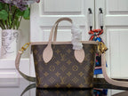 Louis Vuitton monogram tote bag with pale leather handles and side strap
