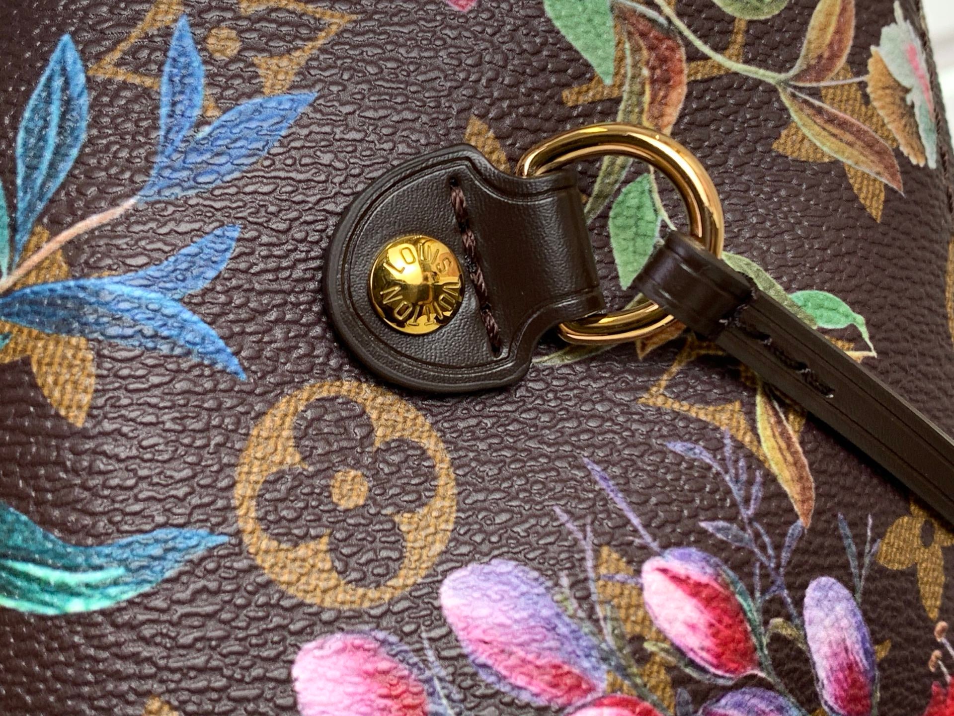 Leather key ring with gold LV coin charm on floral monogram tote