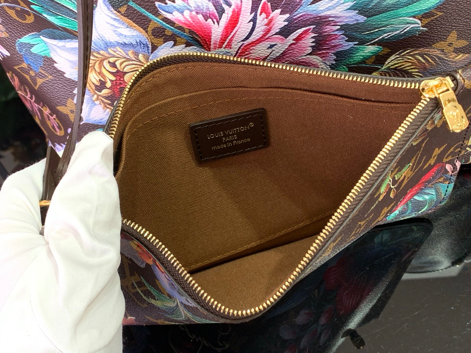 Tote bag interior pocket with Louis Vuitton logo patch and brown lining