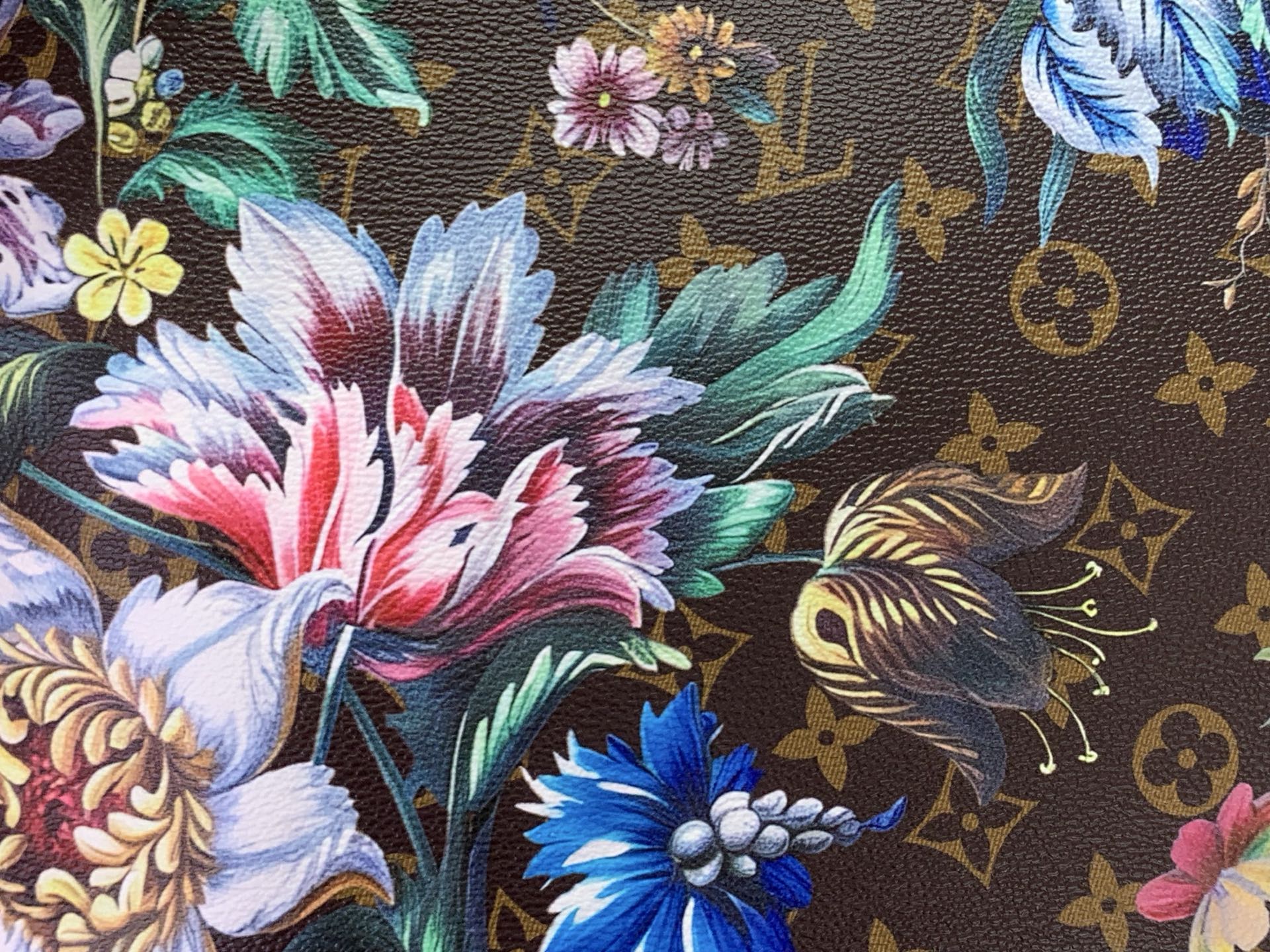 Floral patterned fabric panel on tote bag with brown monogram motifs