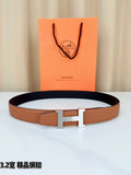Brown leather belt with gold H buckle, laid flat on a white surface.