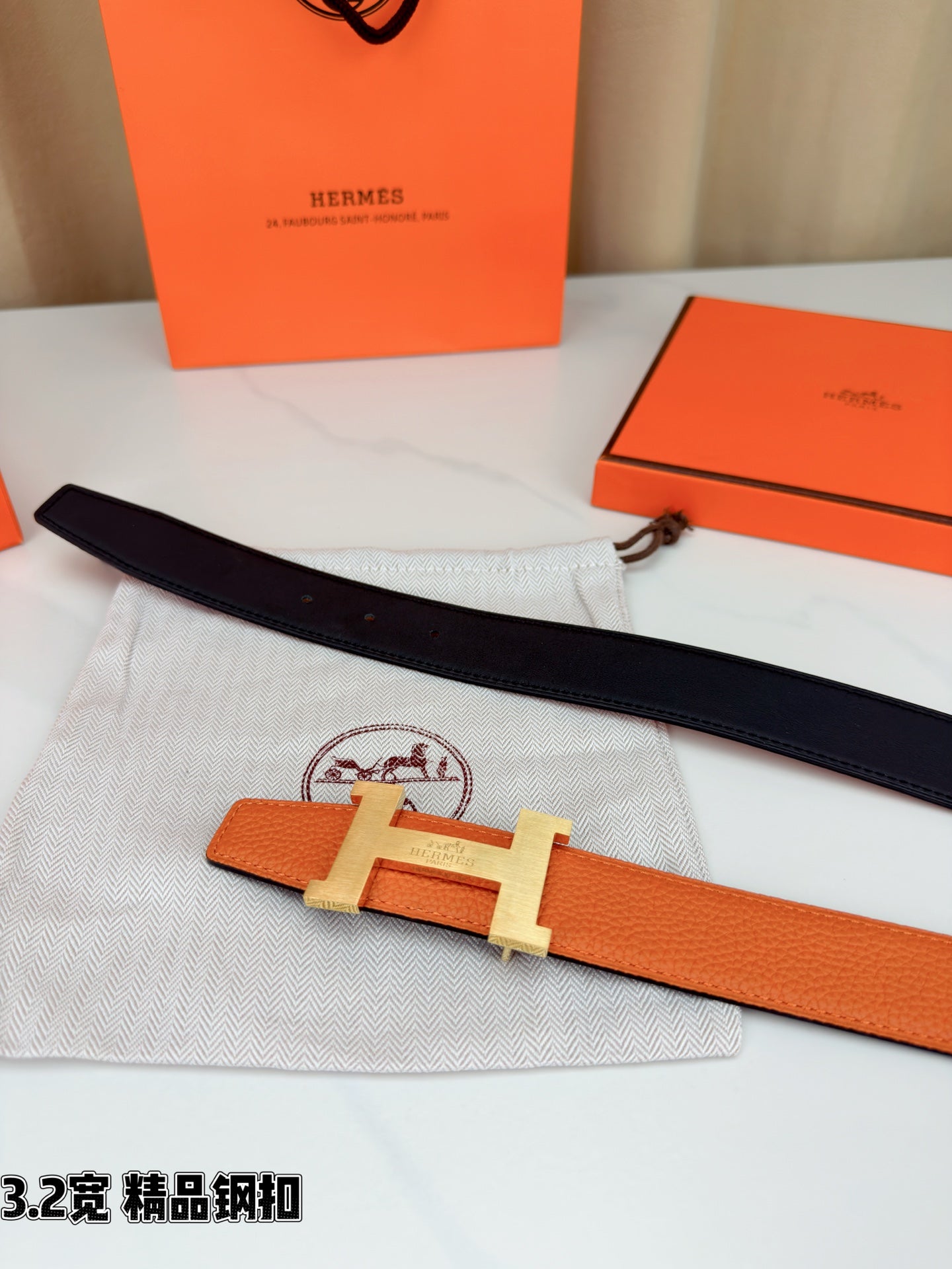 Two-tone belt with orange leather and black strap, metal H buckle on cloth