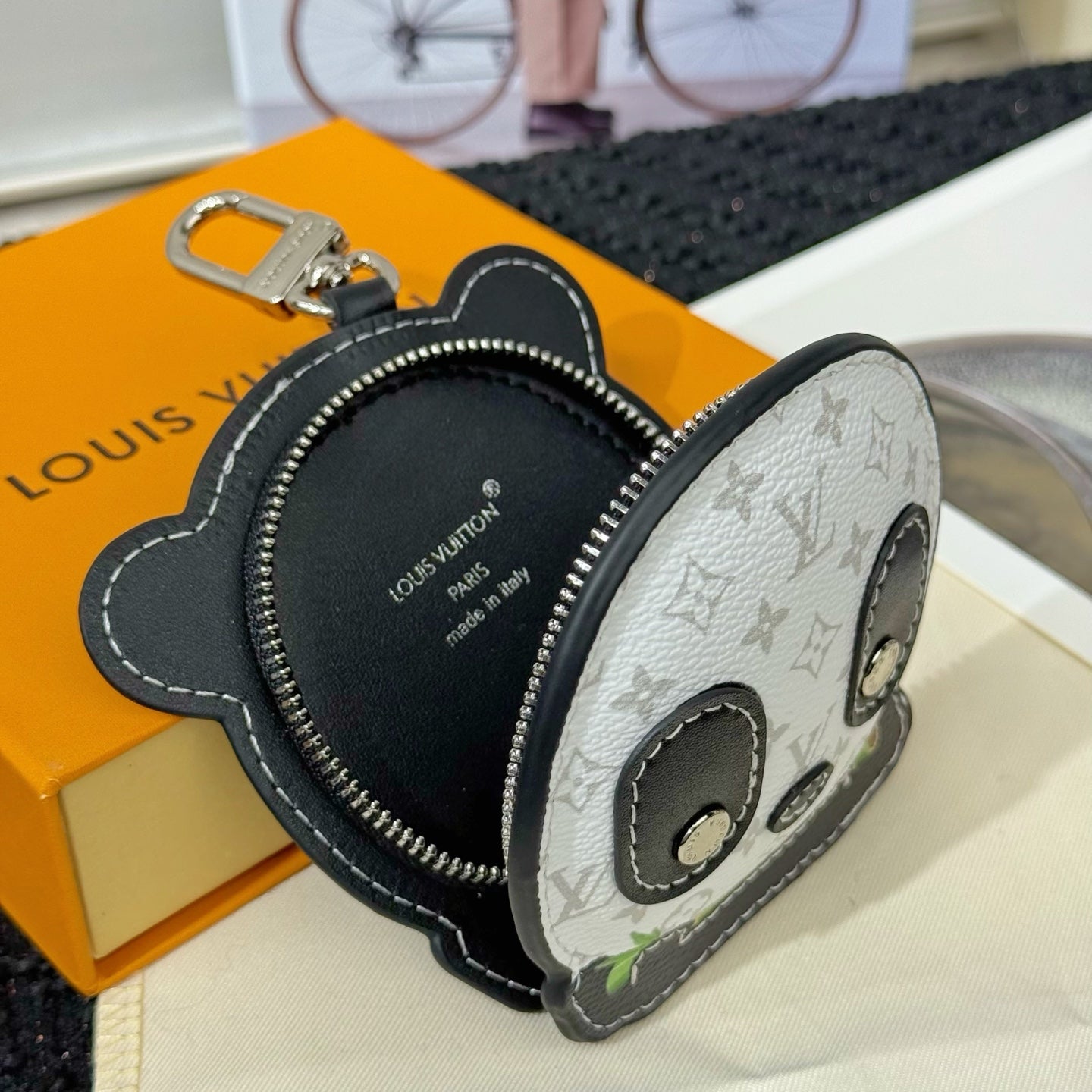 Louis Vuitton key pouch angled view showing monogram white front and dark trim