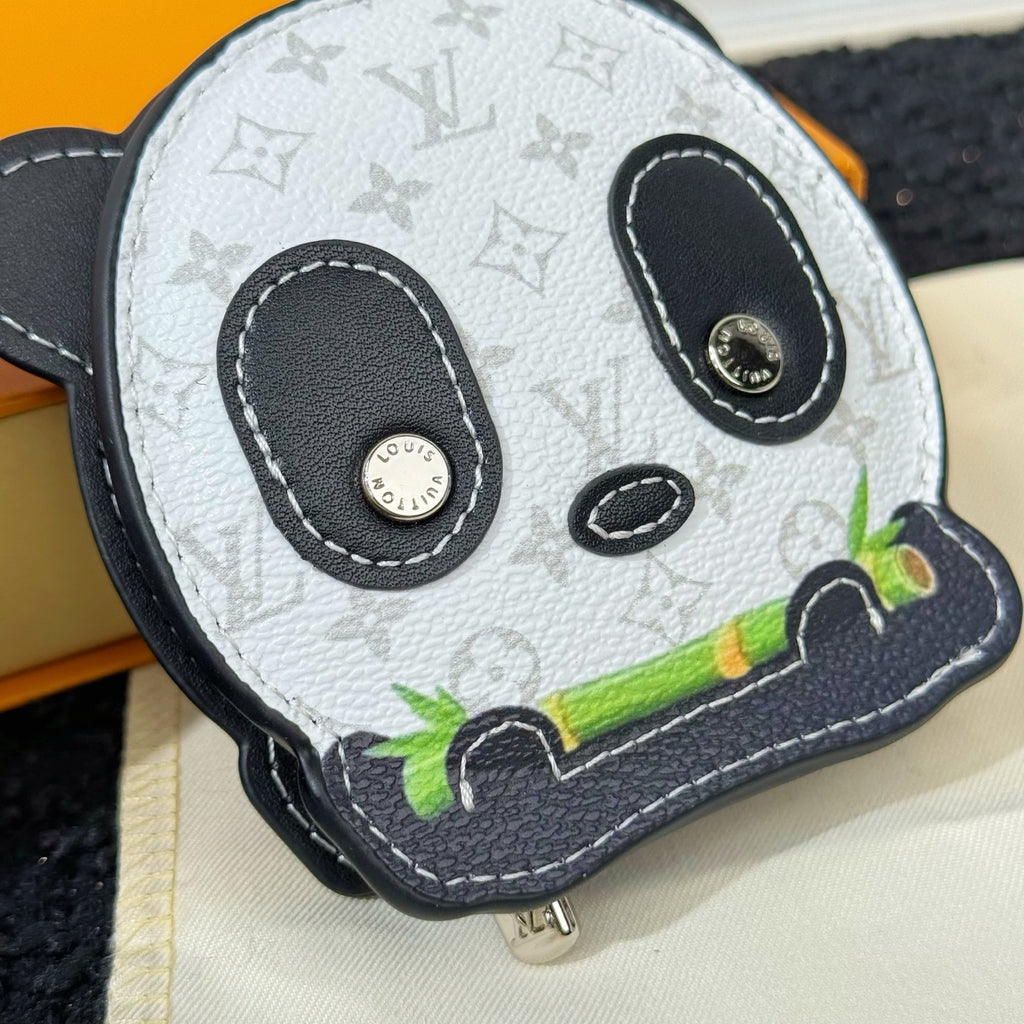 Louis Vuitton panda key pouch close-up with zip pull, black eyes and green accent