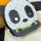 Louis Vuitton panda key pouch close-up with zip pull, black eyes and green accent