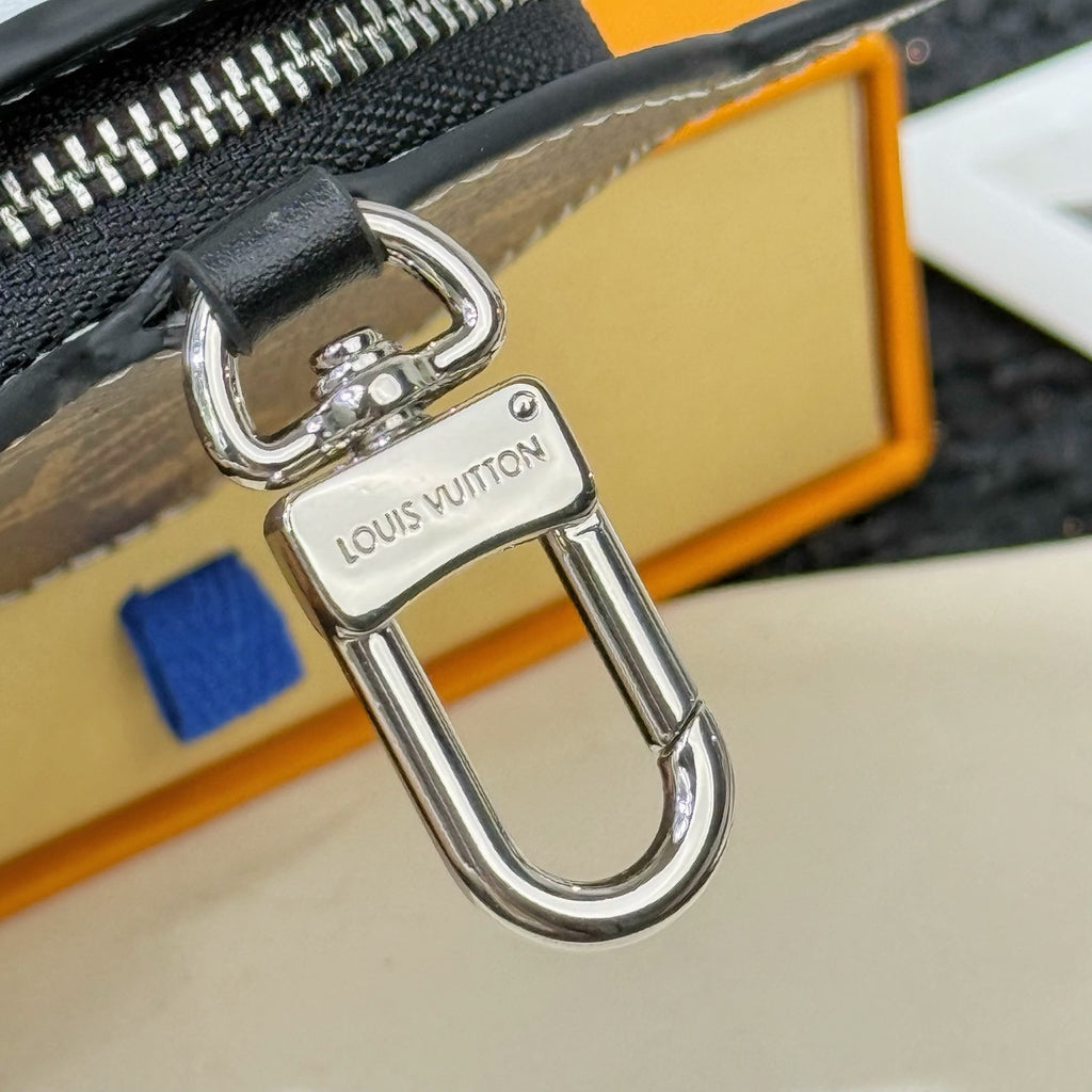 Louis Vuitton metal key clip with lobster clasp and attached zipper pull
