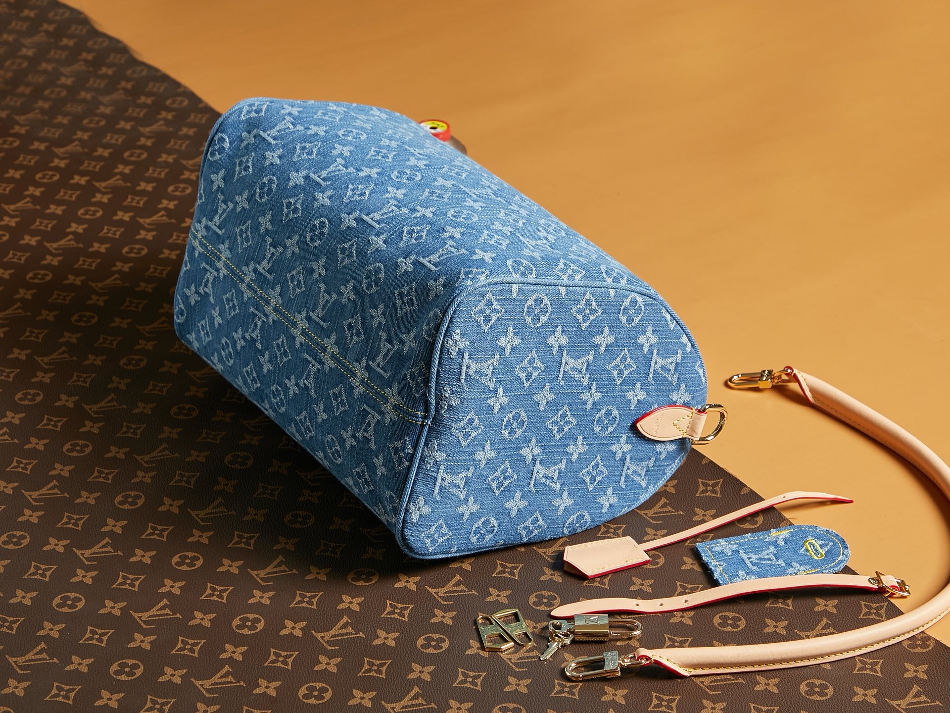 Blue Louis Vuitton monogram duffel-style bag with rolled handle and zip top.