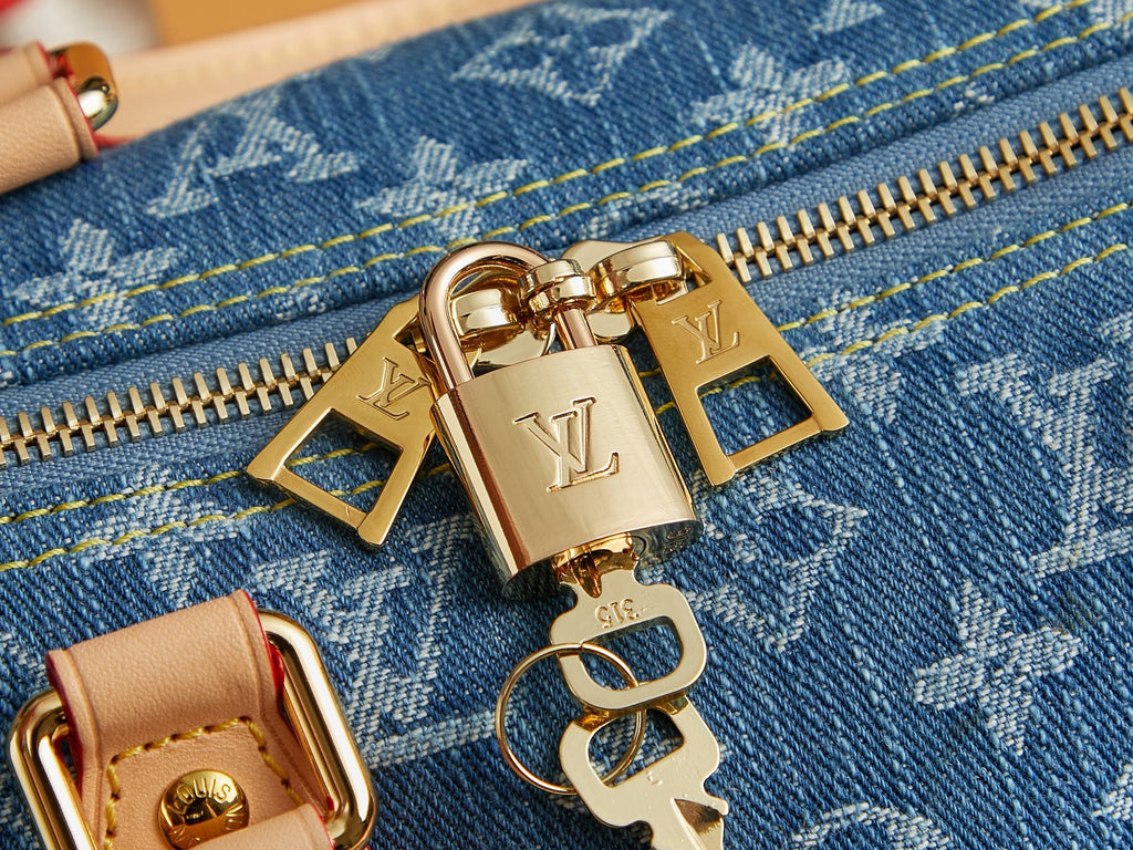 Close-up of Louis Vuitton hardware and zipper on blue monogram denim bag.